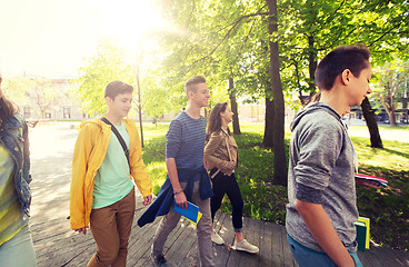 Image showing group of happy teenage students walking outdoors