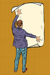 Image showing man unfolded poster paper, announcement on the wall