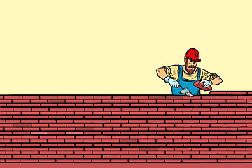 Image showing The Builder lays brick masonry in the middle