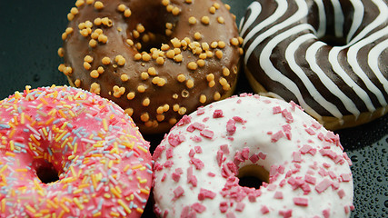 Image showing Glazed sweet doughnuts in closeup