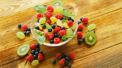 Image showing Fruit salad in bowl on table 