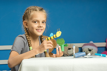 Image showing Merry girl plays in a makeshift finger puppet show