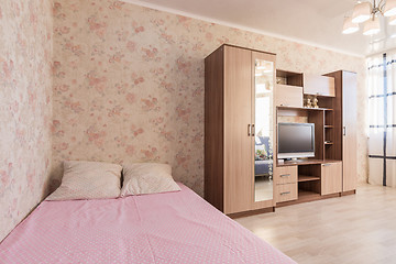 Image showing Interior of the hotel room, bed, wardrobes, TV