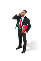 Image showing Happy businessman talking on the phone with folder in hand isolated over white background in studio shooting