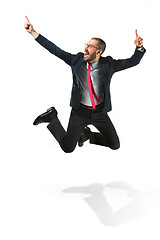 Image showing Funny cheerful businessman jumping in air over white background