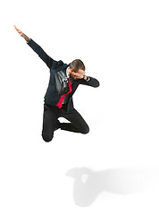 Image showing Funny cheerful businessman jumping in air over white background