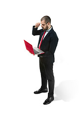 Image showing Picture of handsome young bearded man standing over white studio background with laptop