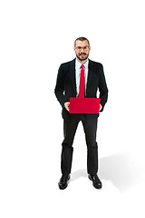 Image showing Picture of handsome young bearded man standing over white studio background with laptop