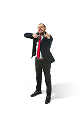 Image showing Angry businessman threatening and pointing to camera. Isolated on white.