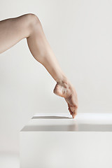 Image showing Close-up ballerina\'s legs on the white floor