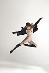 Image showing Young beautiful dancer in beige swimsuit dancing on gray background