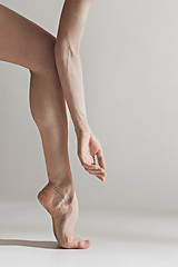 Image showing Close-up ballerina\'s legs on the white floor