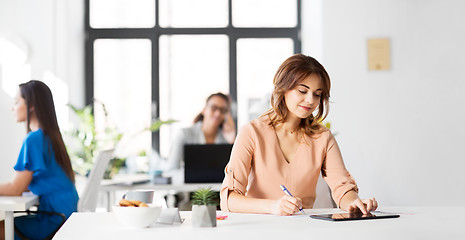 Image showing businesswoman with tablet pc working at office