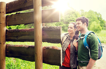 Image showing smiling couple with backpacks hiking