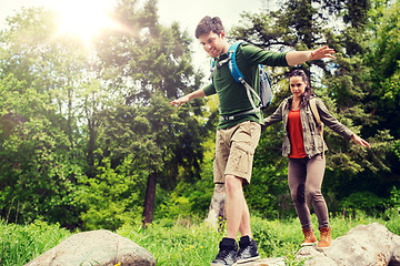 Image showing happy couple with backpacks hiking outdoors