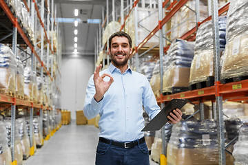 Image showing businessman with clipboard at warehouse showing ok