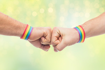 Image showing hands with gay pride wristbands make fist bump