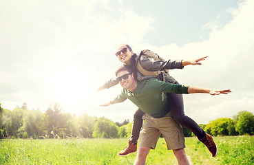 Image showing happy couple with backpacks having fun outdoors