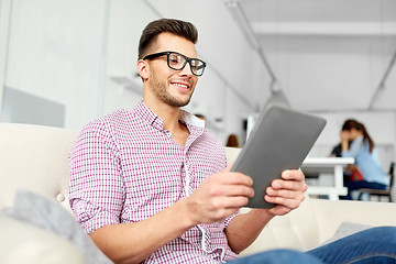 Image showing man in glasses with tablet pc working at office