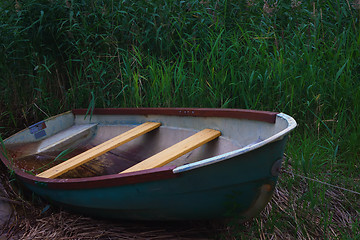 Image showing Old Metal Rowing Boat On The Background Of Reeds