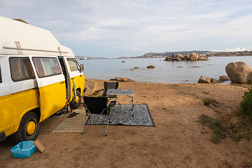 Image showing Vintage minivan car on camping spot on beach on Sardinia island, Italy.