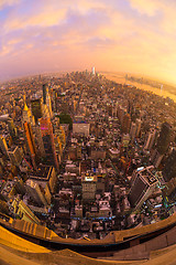 Image showing New York City skyline with Manhattan skyscrapers at dramatic stormy sunset, USA.