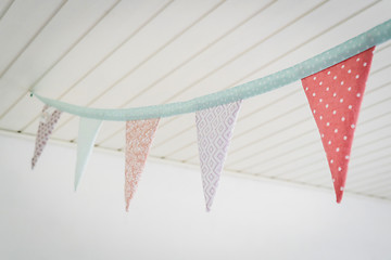 Image showing Colorful birthday flags in pastel colors hanging from a ceiling