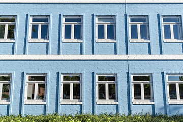 Image showing Blue brick house with white windows