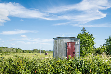 Image showing Wooden shed on a rural field