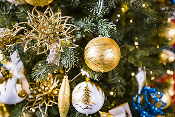 Image showing Christmas tree with shiny baubles on a decked tree