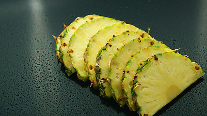 Image showing Slices of fresh pineapples in row