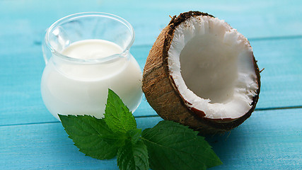 Image showing Cup of milk and half of coconut