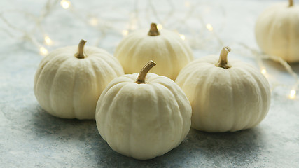 Image showing White pumpkins with garland