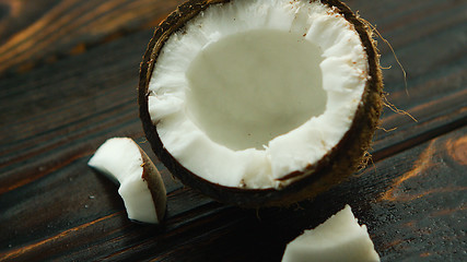 Image showing Cracked coconut on table 