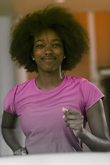 Image showing afro american woman running on a treadmill