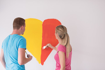 Image showing couple are painting a heart on the wall