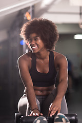 Image showing black woman doing sit ups at the gym