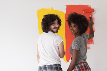 Image showing multiethnic couple painting interior wall