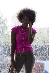 Image showing portrait of young afro american woman in gym while listening mus