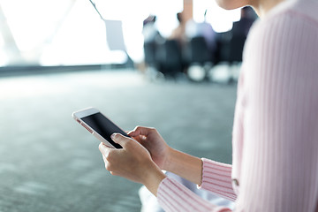 Image showing Woman using cellphone in meeting room