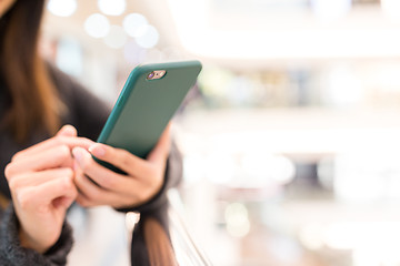 Image showing Woman sending sms on cellphone