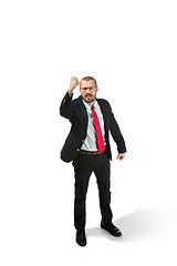 Image showing Angry businessman threatening and pointing to camera. Isolated on white.