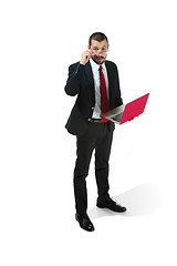 Image showing Picture of handsome young bearded man standing over white studio background with laptop