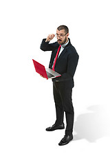 Image showing Picture of handsome young bearded man standing over white studio background with laptop