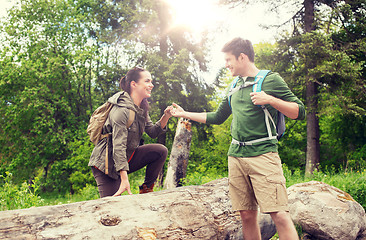 Image showing smiling couple with backpacks hiking