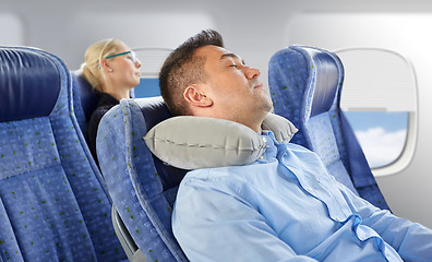 Image showing man sleeping in plane with cervical neck pillow