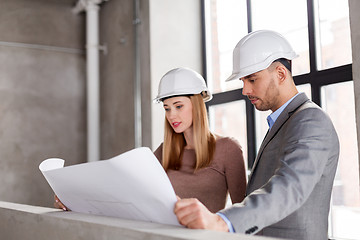 Image showing architects with blueprint and helmets at office