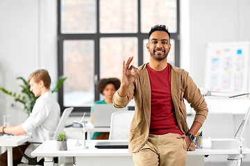 Image showing smiling indian man showing ok hand sign at office