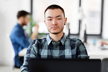 Image showing creative man with laptop working at office