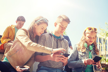 Image showing teenage friends with smartphone and headphones